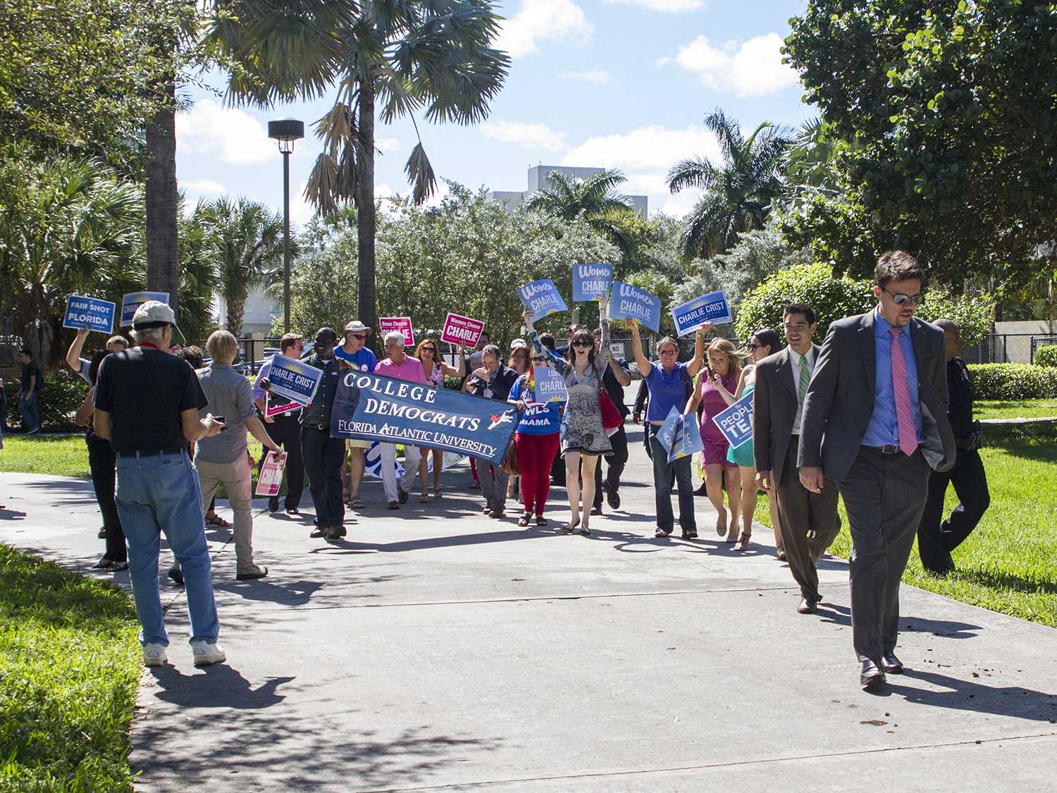 The FAU chapter of College Democrats greets Charlie Crist as he walks toward the free speech lawn. Crist is currently running as a Democrat, but has run as an Independent and Republican in past years.  [Sabrina Martinez | Assistant Creative Director]