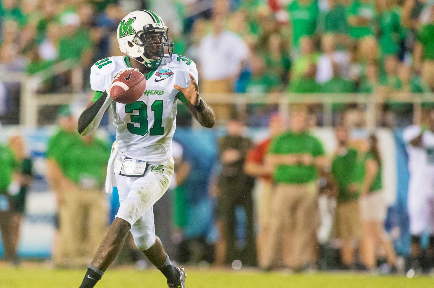 Marshall quarterback Rakeem Cato (31) looks for an open receiver in the fourth quarter of play.  Cato, wearing 31 to honor injured teammate Evan McKelvey, finished the game with 281 yards and three touchdowns. 