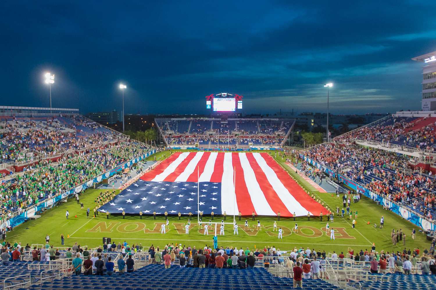 A 100-yard long American flag is held out during the singing of the National Anthem prior to the first-ever kick off of the Boca Raton Bowl. 