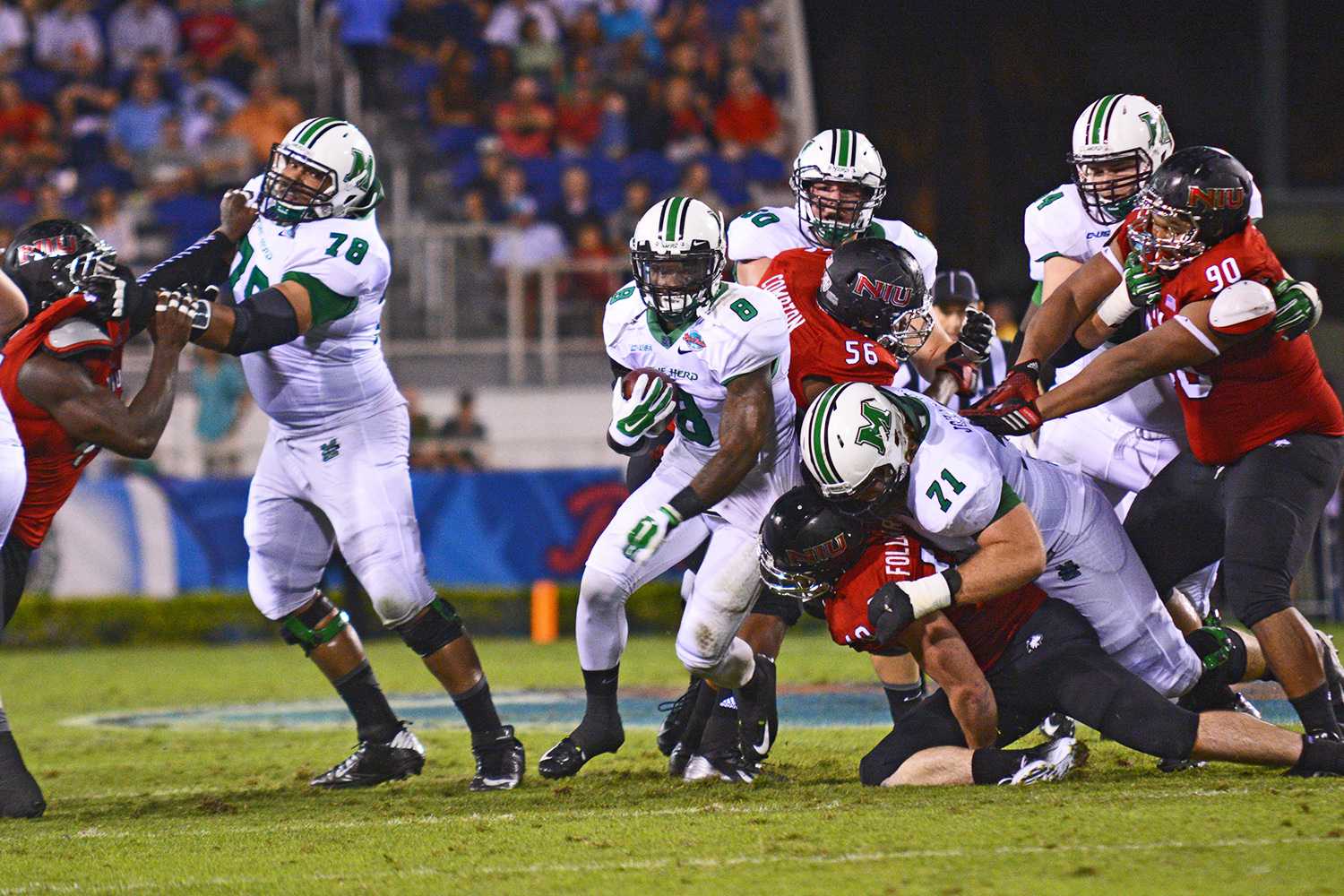 Marshall running back Remi Watson knifes through a gap for what became a 25-yard gain.  