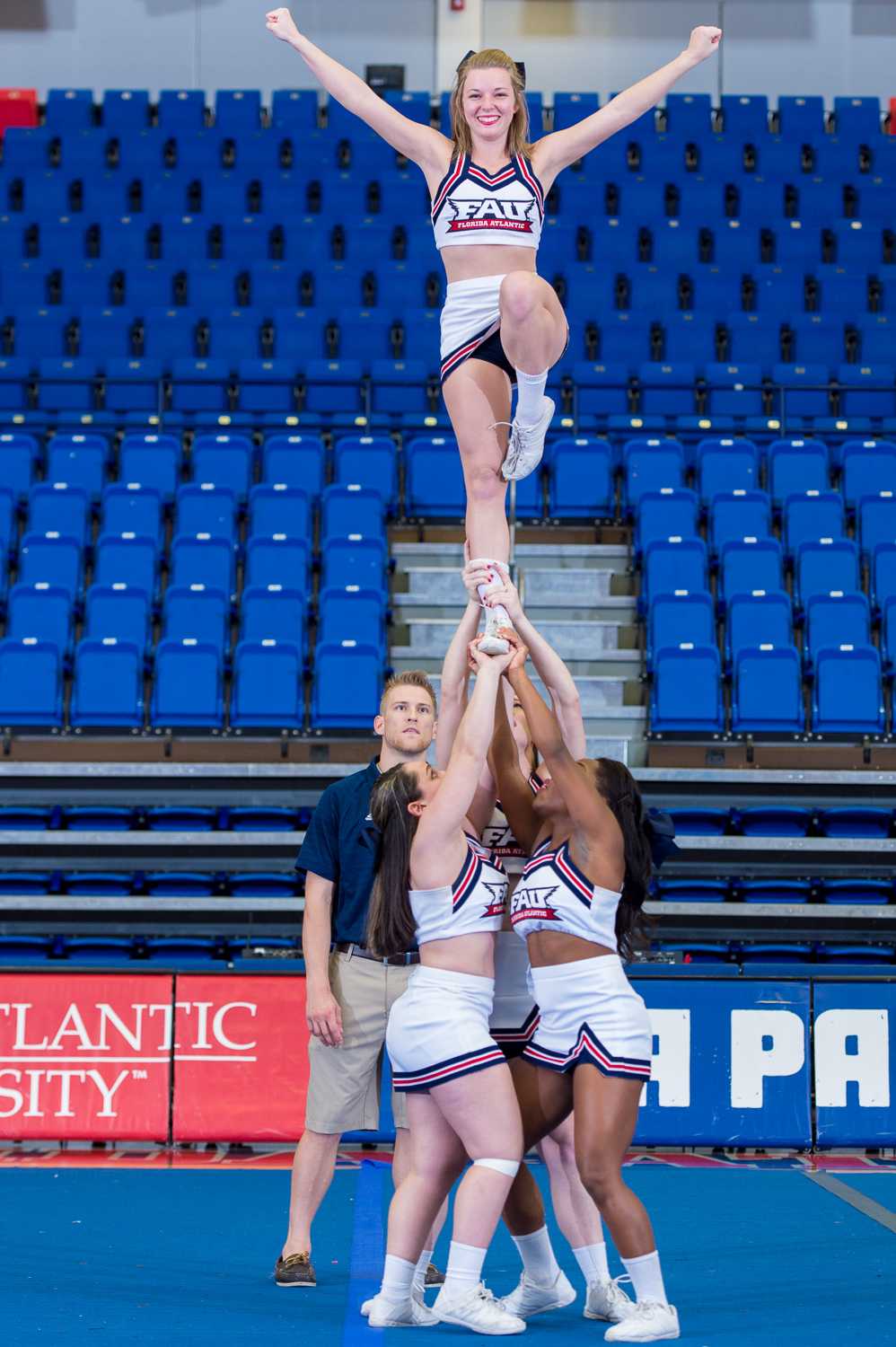 FAU Cheerleaders Marisa Paglino (left), Amanda Johnson (back),  Colette Bienvenu( right) and Kelsey Miller (top) pull a Liberty at the 2015 FAU Dance Team Showcase in The Burrow.  