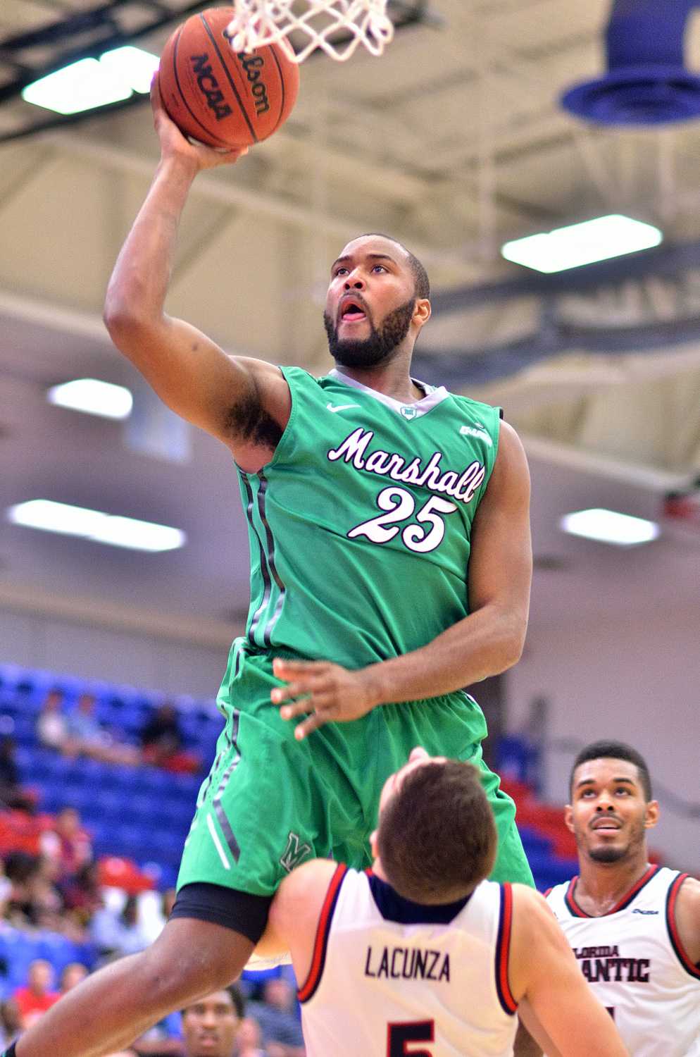 Marshall forward Ryan Taylor (25) cruises to complete a layup against FAU forward Javier Lacunza (5). Taylor led the Thundering Herd with 24 points.