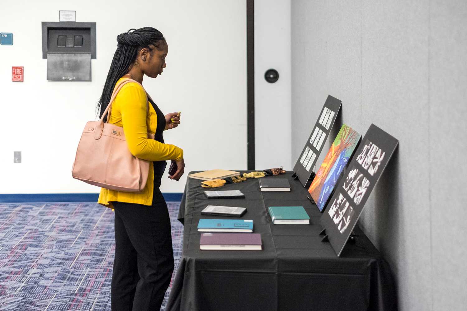 Shamariah Reneau, junior in elementary education, examines the art thats on display during House of Black Culture on Feb. 12th.  
