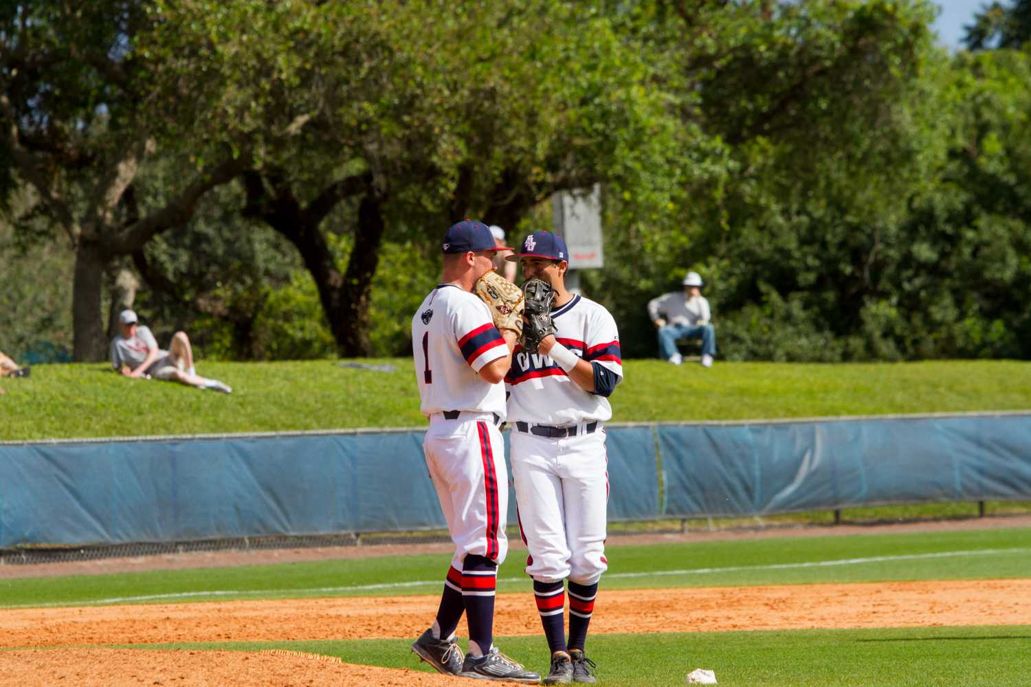 Senior pitcher Bo Logan (1) talks with a teammate in the top of the ninth inning. Logan had the save in The Owls’ 2-1 win against The Buckeyes.