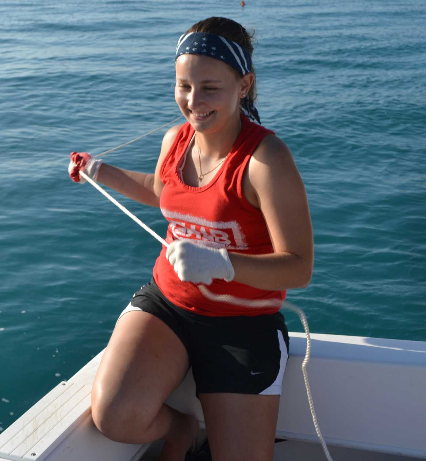 Eloise Cave holds a line on the FAU research boat. Photo courtesy of Stephen Kajiura