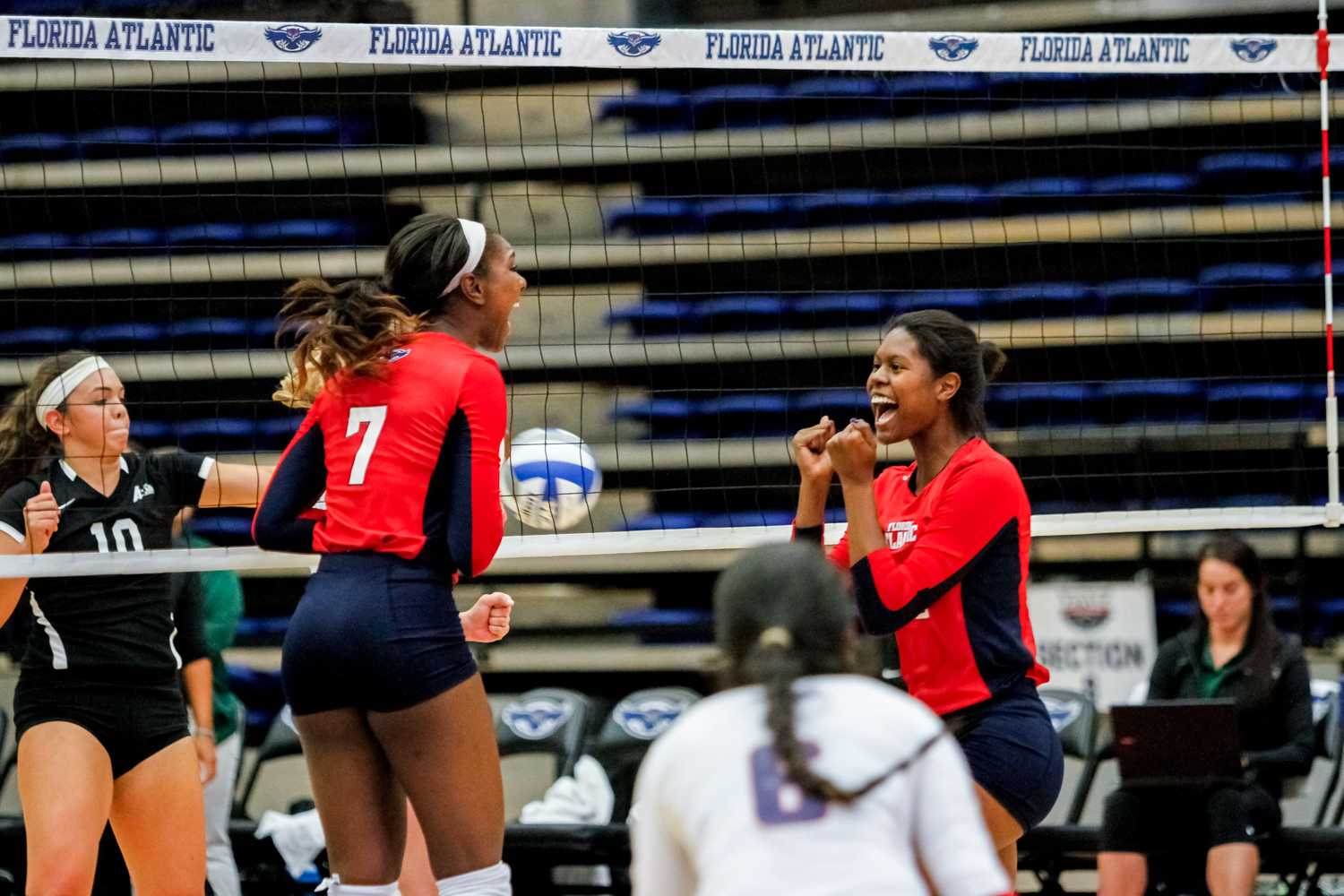 Middle blocker Brittney Brown (left) and opposite hitter Gabrielle Dixon (right) celebrate after earning a point for the Owls. Mohammed F Emran | Staff Photographer