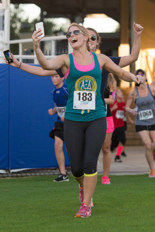 Senior business major Haley Brueggemann takes a selfie during the Homecoming Run for Autism. Photo by Max Jackson