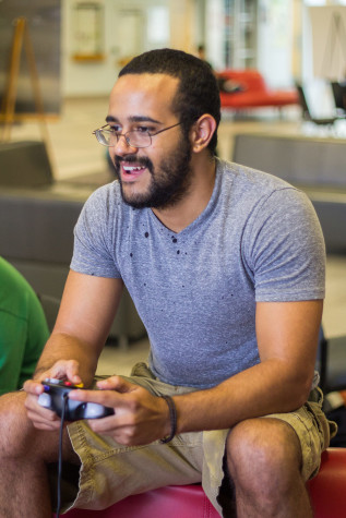 Junior ocean engineering major Justin Dalton playing video games at the Student Union on the Boca Raton campus. Photo by Andrew Fraieli