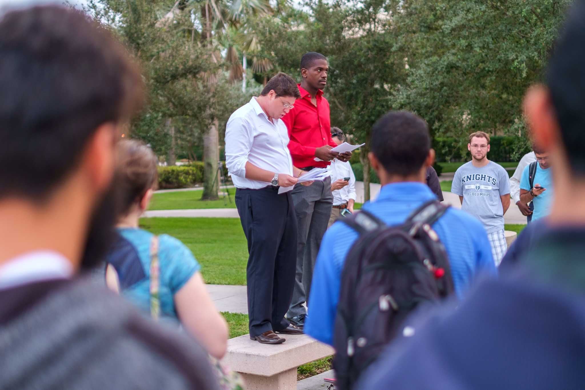 Zachary Pastor (left), senior studying pre­law criminal justice, gives a speech in front of 50 attendance during the Nov. 16 vigil for Paris. | Mohammed F Emran, Asst. Creative Director