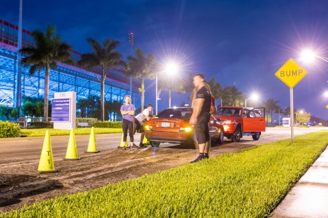 Nick Peragine, an exercise science student at FAU, stands by his stranded Volvo after trying to leave campus on Thursday evening. Max Jackson | Staff Photographer