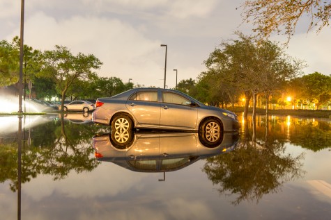 A Toyota Camry sits in over 6 inches of water behind University Village Apartments early Friday morning after Thursday evening’s downpour flooded the area. Max Jackson | Staff Photographer