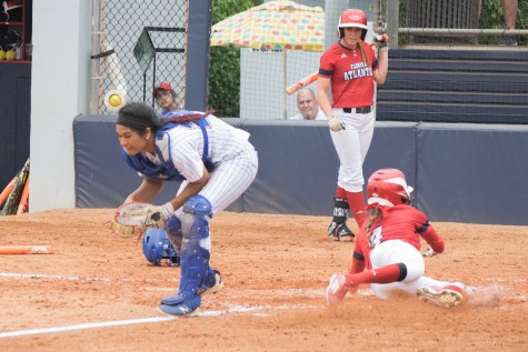 Senior outfielder Christina Martinez slides in safe after a sacrifice fly by her twin sister Melissa, scoring the first run of Sunday’s game between the Owls and Louisiana Tech. Ryan Lynch | Multimedia Editor