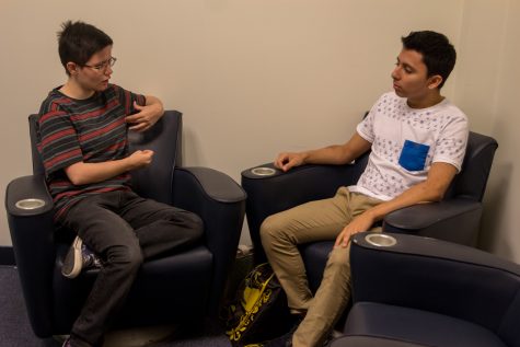 Roman Alexander talks with sophomore biology major Gerardo Ruiz in the LGBTQA center, Room 206 on the second floor of the Student Union. Photo by Andrew Fraieli