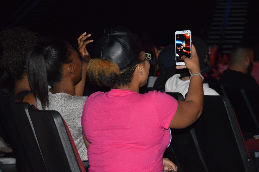 A student takes a photo of the stage during the start of the drag show. Kaylyn Koutz | Contributing Photographer