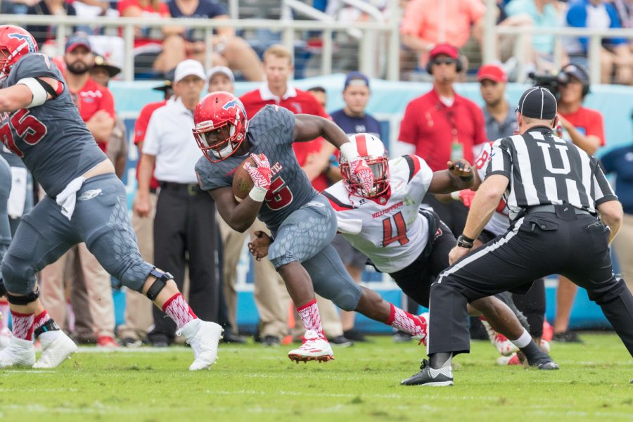 Hilltoppers sophomore linebacker Joel Iyiegbuniwe (4) dives to tackle FAU redshirt freshman running back Devin Singletary (5) as he tries to gain yards for the Owls. Brandon Harrington | Staff Photographer