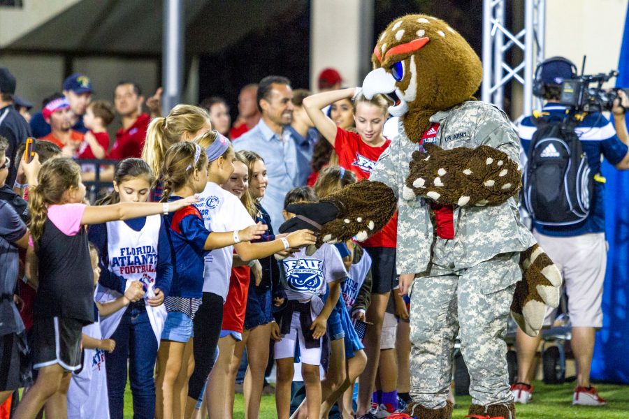 Owlsley greets kids making a “high five line” before the start of FAU’s game versus UTEP. Alexis Hayward | Contributing Photgrapher