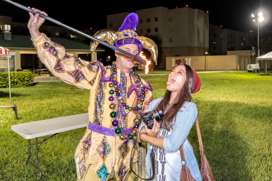 [Mohammed Emran |  Contributing Photographer]  Alexis H. (Freshman in Communications) poses with one of the jesters who spun fire during the carnival.