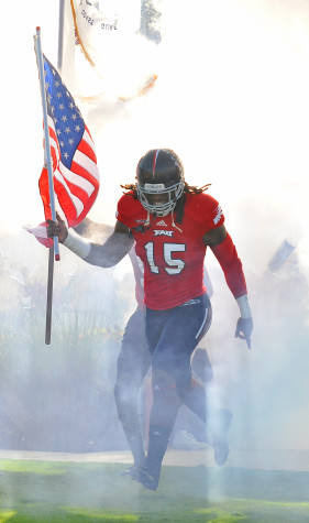 Randell Johnson leads his team out of the tunnel before a game versus New Mexico State on November 23. Photo by Michelle Friswell