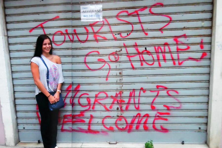FAU student Holly Olsen stands in front of graffiti in San Zaccaria in Venice, Italy during her study abroad trip in summer 2014. Photo courtesy of Holly Olsen.