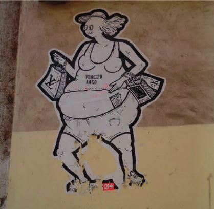 Graffiti of an Italian portrayal of American tourists in Venice, Italy outside San Marco. The photo was taken by an FAU student studying abroad in Venice in summer 2014. Photo courtesy of Holly Olsen.