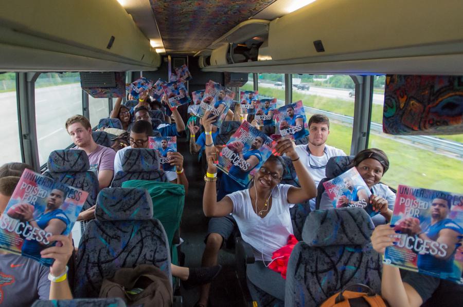 [Max Jackson | Photo Editor] FAU students took three buses leaving the Boca campus on the evening of Friday, Sept. 5.  Pictured are bus riders reading the University Press’ Football Special Issue.