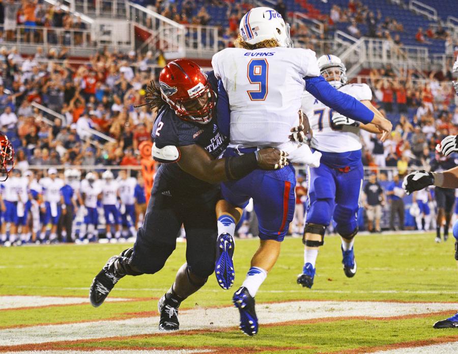 Brandin Bryant throws Tulsa quarterback Dane Evans to the ground during a game on September 13. Photo by Michelle Friswell, Creative Designer