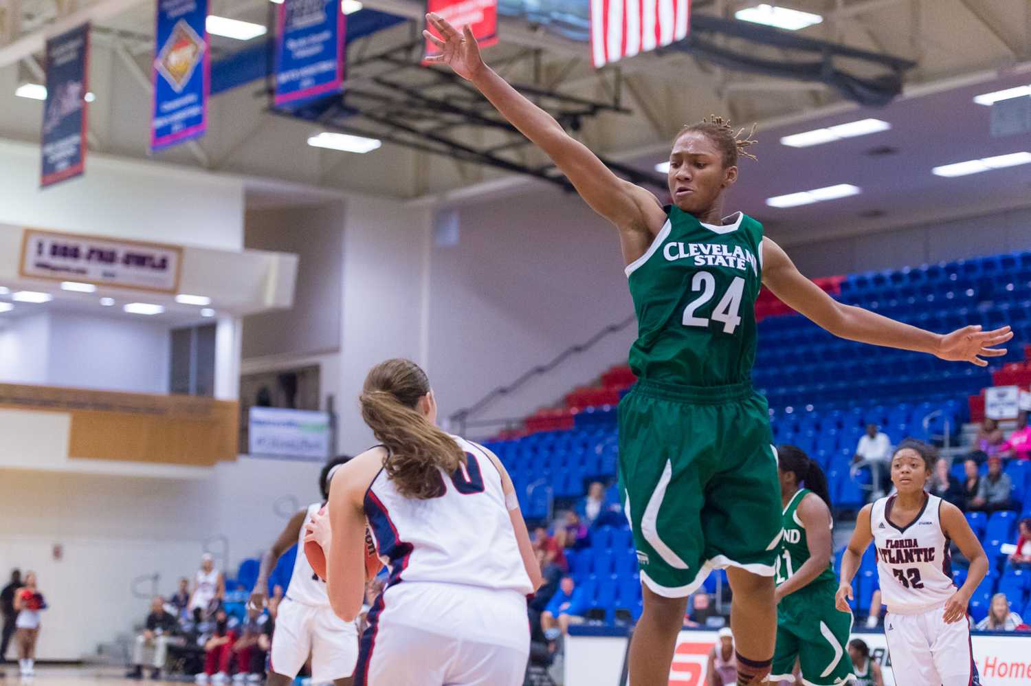 Cleveland State guard Alexis Eckles jumps in attempt to block a shot from Owl guard Melinda Myers in the first half. 