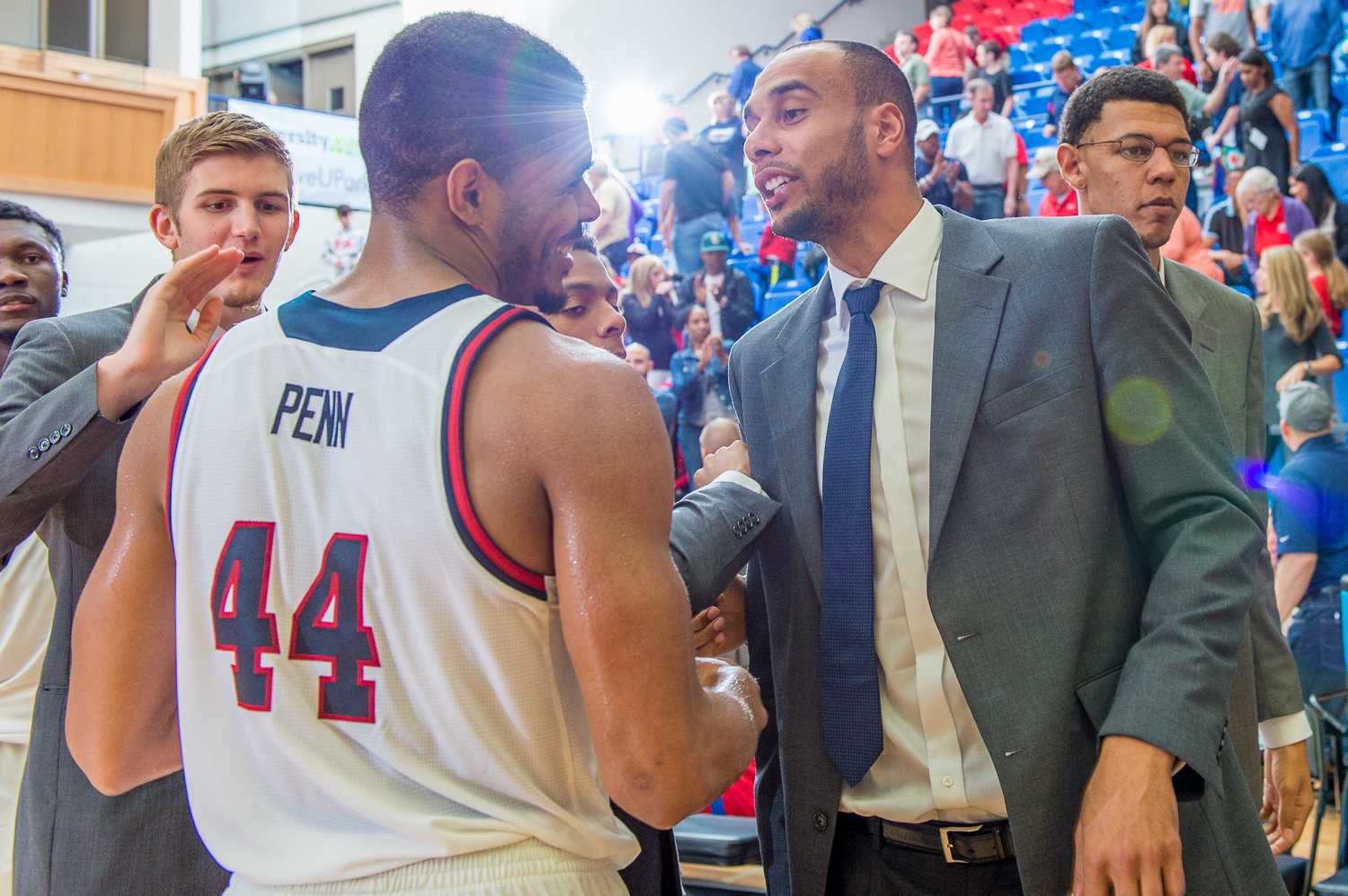 Injured FAU forward Justin Raffington, congratulates Penn (44) after FAU’s 76-62 victory over Marshall. Raffington has missed several games with a stress fracture in his foot.
