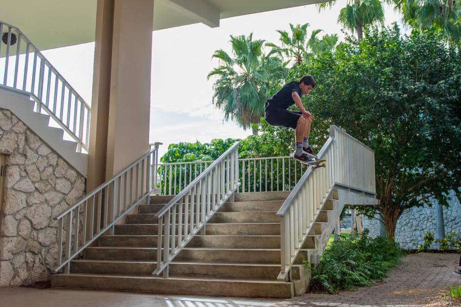 A student from Henderson Middle School on FAU’s campus attempts a trick on his skateboard in the breezeway. 