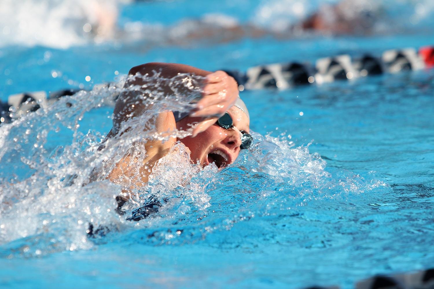 An FAU womens swimmer in the midst of the freestyle.
