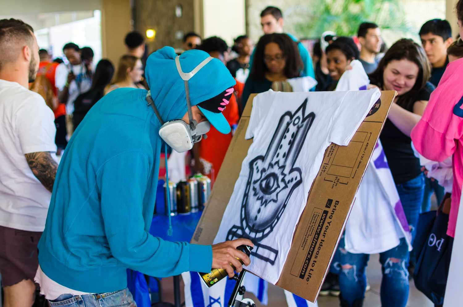 The graffiti artist putting finishing touches on a shirt requested by a student during the “Artists for Israel” event on Feb 12.