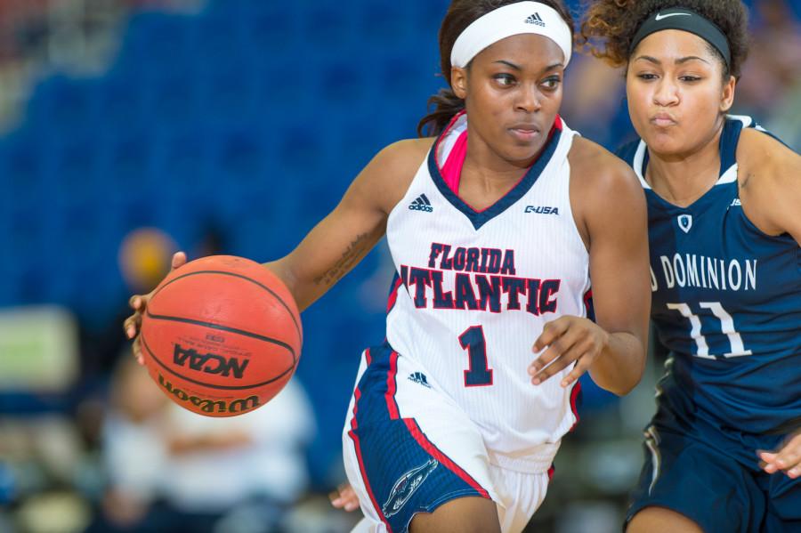 Aaliyah Dotson (1) of FAU drives to the paint  around Ashley Betz-White (11) of ODU.