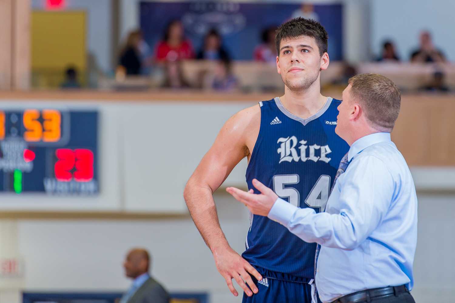 Andrew Drone (54) of the Rice Owls listens to his coach while FAU shoots a free throw.