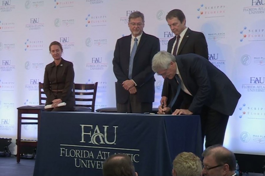 John Kelly (third from the left) first announced his plans to convert the Jupiter campus into a research facility in October 2014. [Photo via screenshot of FAU live stream]