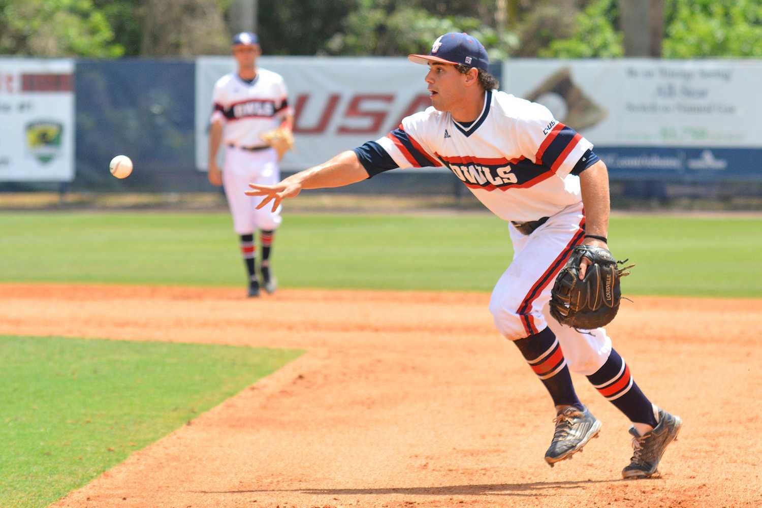 Redshirt sophomore first baseman Esteban Puerta attempts to throw out a runner to hold Marshall to one run in Sunday’s 6-1 victory. Marshall Friswell | Associate Editor 