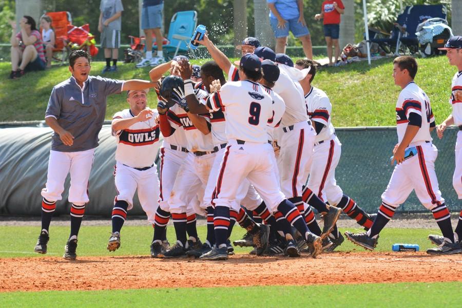 Third baseman Ricky Santiago is swarmed by his team as his extra innings sacrifice hit wins the Sunday game for the Owls. Michelle Friswell | Associate Editor 