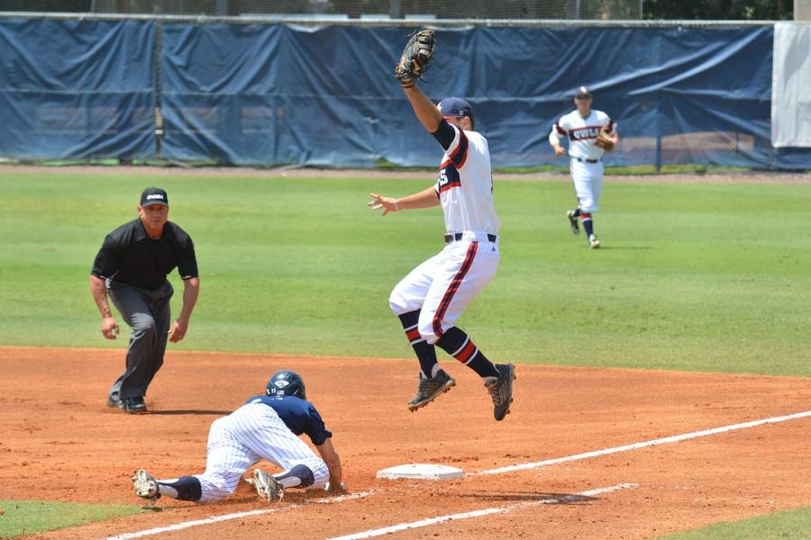 First baseman Esteban Puerta jumps while attempting to catch a throw during the third game of the series. FAU lost the game 5-2. Photo by Michelle Friswell