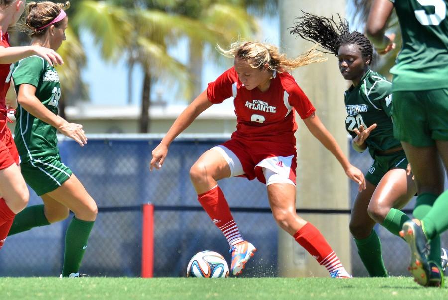 Captain and senior midfielder Claire Emslie dodges a defender during the Owls matchup versus Stetson in 2014. Emslie netted a goal and had an assist in the teams 4-1 win against Stetson in this years matchup. Photo by Ryan Murphy.