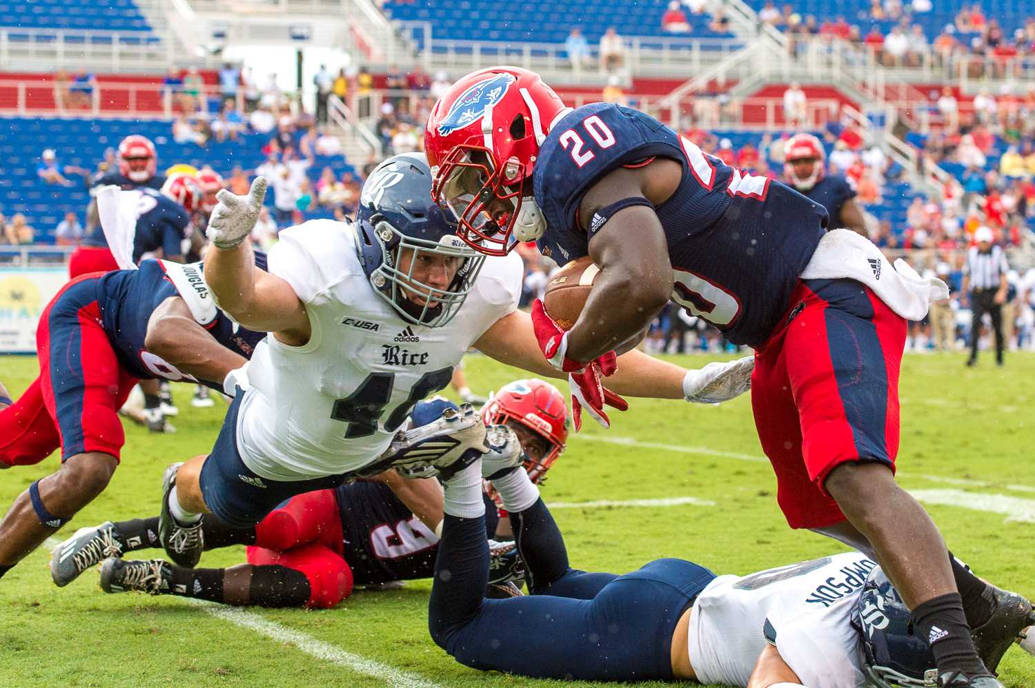 FAU running back Marcus Clark (20) steps out of bounds before being tackled by Rice defensive end Brady White (40). Clark had three carries for a total of 48 yards on the day. Max Jackson | Staff Photographer 