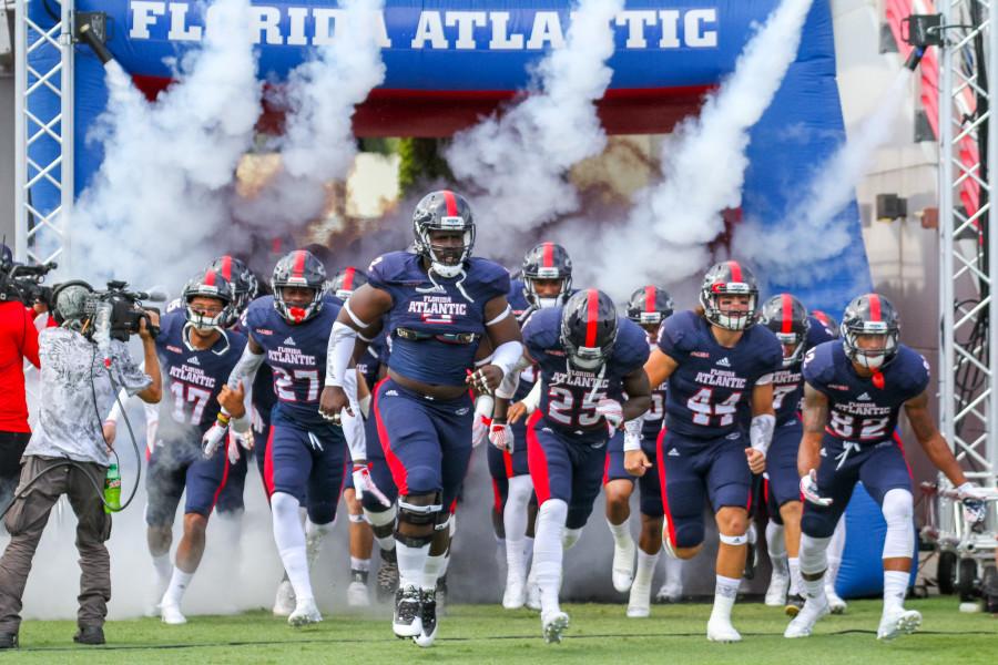 Owls players run out before Saturdays 33-17 loss versus Marshall. FAU is now 0-3 all time versus the Thundering Herd. Photo by Mohammed Emran|Asst. Creative Director