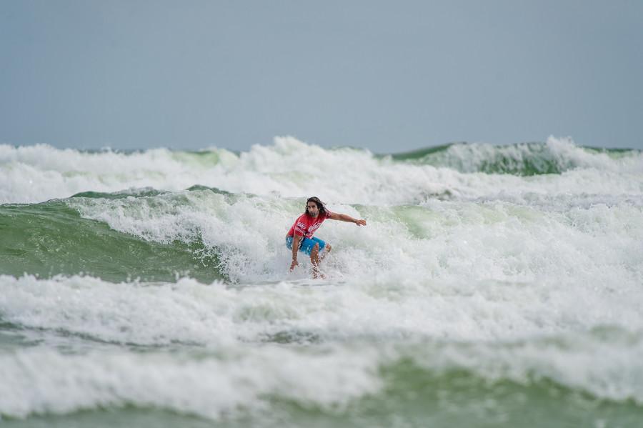 Chris Rubsaman rides a wave during the Oct. 18 Southeast National Scholastic Surfing Association surfing competition. Max Jackson | Staff Photographer