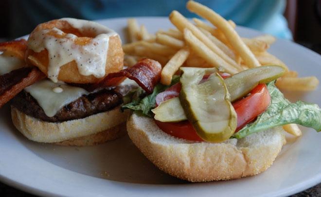 All of Brewzzi’s burgers come with your choice of french fries, Copperstown potato salad, onion strings, cottage chips or fresh slaw as a side. Photo courtesy of Brewzzi’s website.