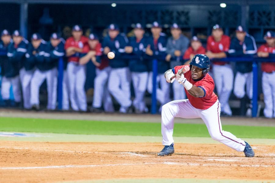Senior outfielder Christian Dicks squares to bunt during the Owls 5-4 win over Miami on Feb. 18, 2015. Max Jackson | Staff Photographer
