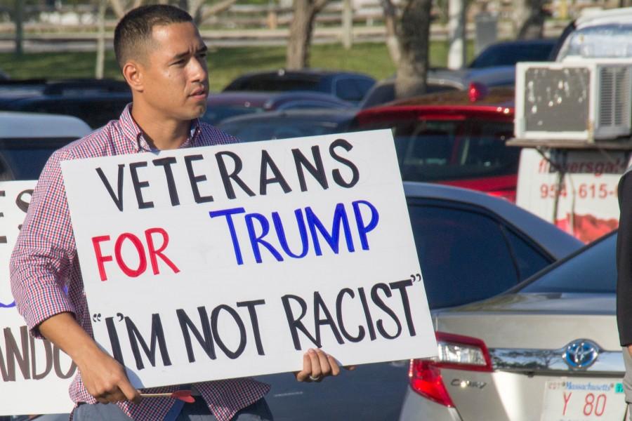 Julio Mackin, 27, a former Navy veteran was with his father and their homeless church Journey To Heaven. He said he wanted show everyone that just because he supports Trump he’s not a racist and neither are the members of his church. Patrick Martin | News Editor