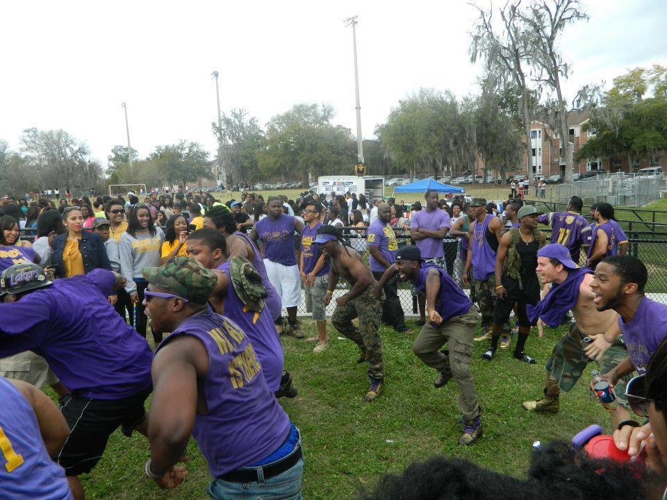 Many of FAU's Omega Psi Phi chapter members wear purple and gold tops with camouflage bottoms at an event. This photo comes from an untitled album from 2012. Photo via Omega Psi Phi Fraternity Inc. - Sigma Delta Delta Chapter (FAU)'s Facebook page.
