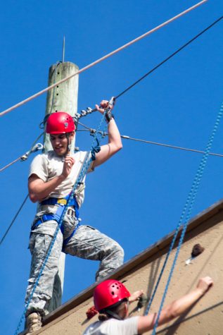 Gabe bugallo, a junior criminology major, prepares to rappel down the wall after making it to the top. "Those little grips are so freaking small," he said referencing the rock wall. Patrick Martin | News Editor