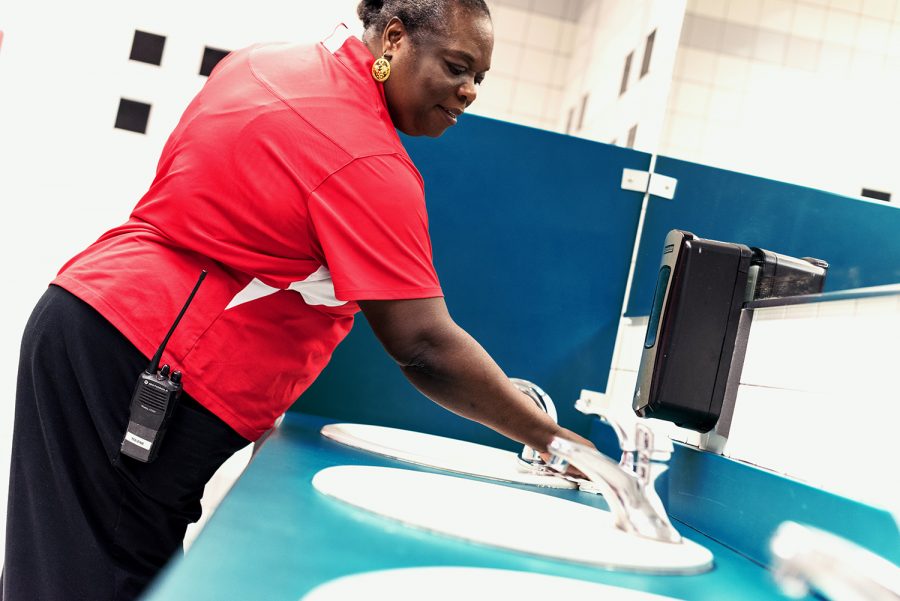 Joseph wipes off the sinks in one of the bathrooms in the Student Union while making her rounds. Patrick Delaney | Photo Editor