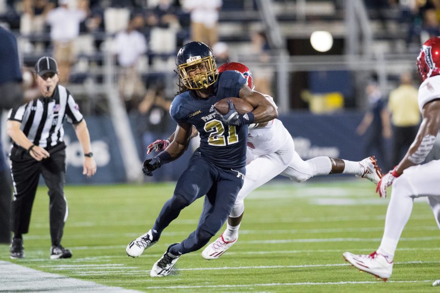 FIU freshman wide receiver Stantley Thomas (21) runs down the sidelines to gain a first down for the Panthers. Brandon Harrington | Staff Photographer