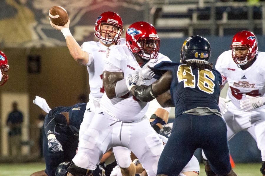 FAU quarterback Jason Driskel (16) throws to a receiver downfield. Driskel completed nine out of 20 pass attempts with a total of 92 yards of passing on the night. Max Jackson | Staff Photographer