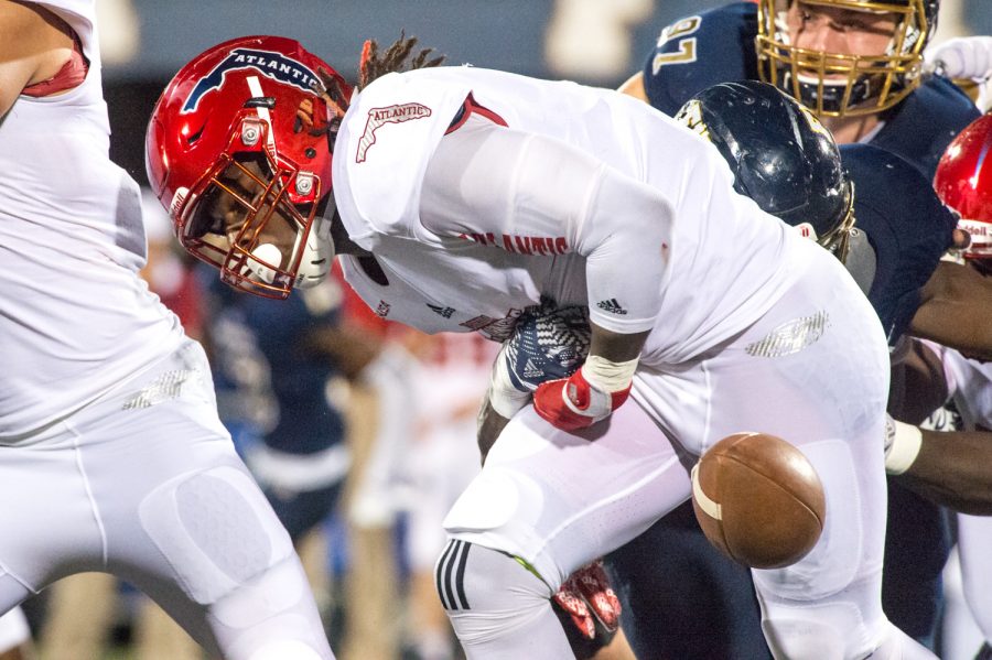 FAU running back Gregory Howell (9) fumbles on FAU’s 26 yard line. The fumble was recovered by FIU defensive lineman Fermin Silva (7). Max Jackson | Staff Photographer